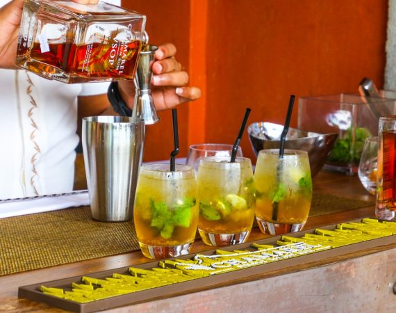 Person laver tropiske drinks i en bar